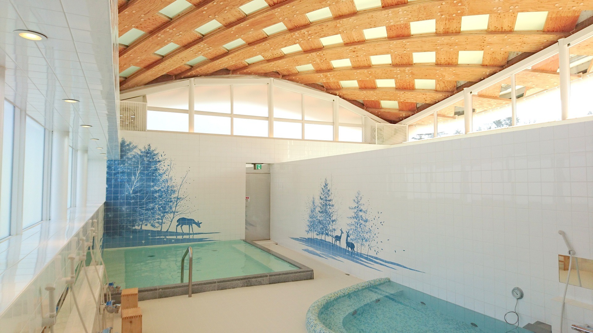 Relaxing indoor hot spring bath with beautiful mountain and sea murals at Onagawa Onsen Yupoppo